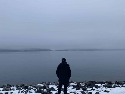 Man looking at ocean in Seward, Alaska